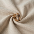 Gold-coloured Ring with ornamental pattern and zirconia edge