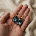 Gold Blue Flower Earrings with Oval Faceted Blue Stones