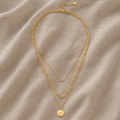 Greta – triple-row gold-coloured Necklace with disc pendant