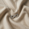Necklace with white gold pendant and zircon infinity symbol