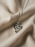 Necklace with heart and bone pendant