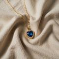 Gold-coloured necklace with blue heart pendant