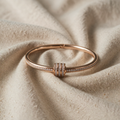 Rose-coloured bracelet with cubic zirconia ring element