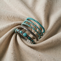 Bracelet with oval turquoise-coloured stones and ornamental edge